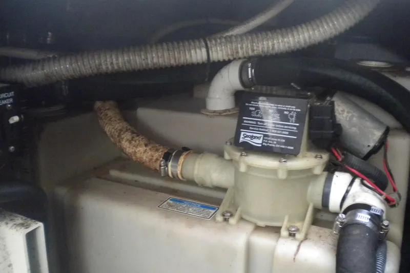 Slide: The Image of Engine compartment of a 2002 Sea Ray 280 Sundancer with visible hoses and components. - 50