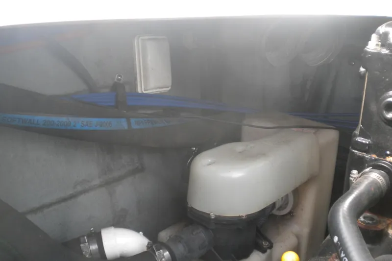 Slide: The Image of Engine compartment of a 2002 Sea Ray Sundancer 280 boat, showing hoses and components. - 53