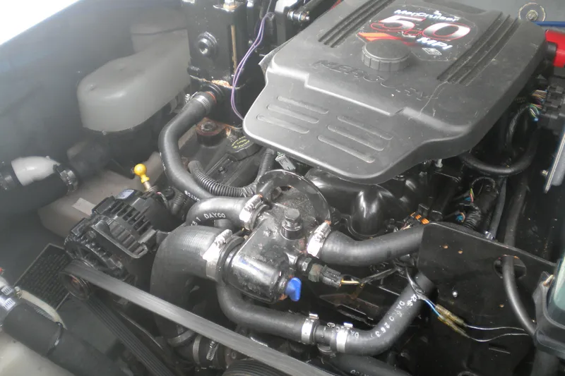 Slide: The Image of Engine compartment of a 2002 Sea Ray Sundancer 280 boat, featuring a MerCruiser 5.0 MPI engine. - 56