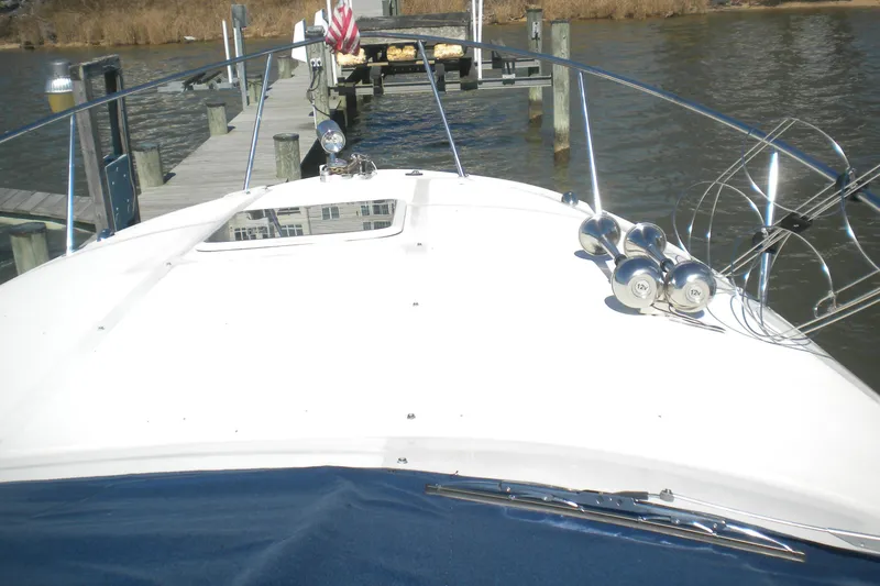 Slide: The Image of 2002 Sea Ray Sundancer 280 docked, showcasing bow and deck details. - 7