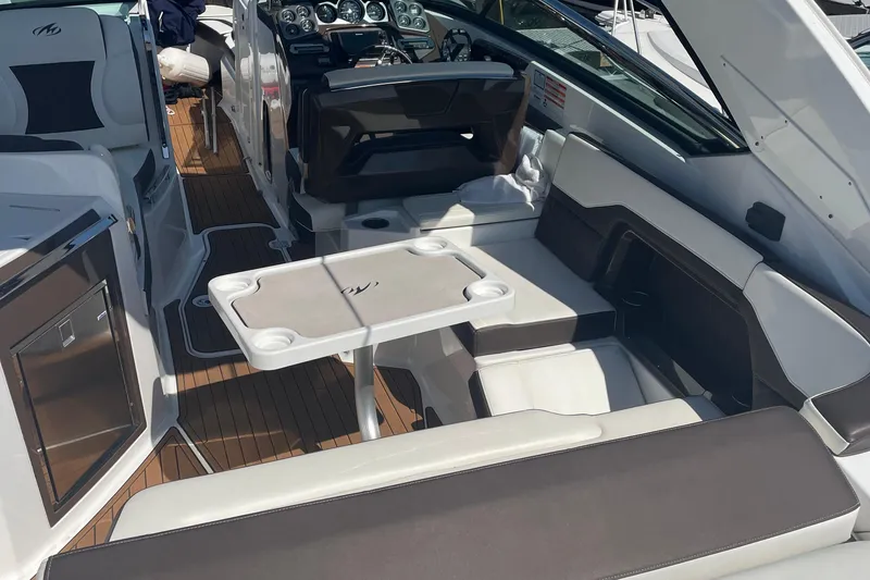 Slide: The Image of 2018 Monterey 328 Super Sport boat interior with seating and control panel. - 10