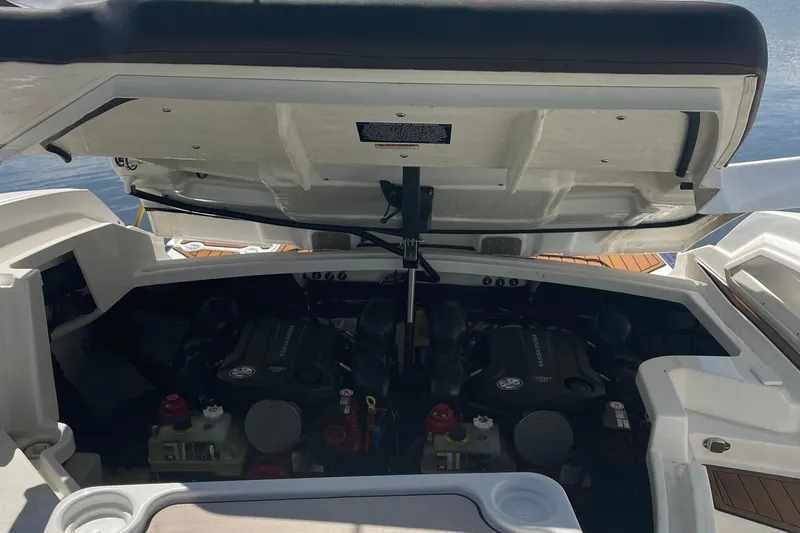 Slide: The Image of Open engine compartment of 2018 Monterey 328 Super Sport boat, revealing dual engines. - 13