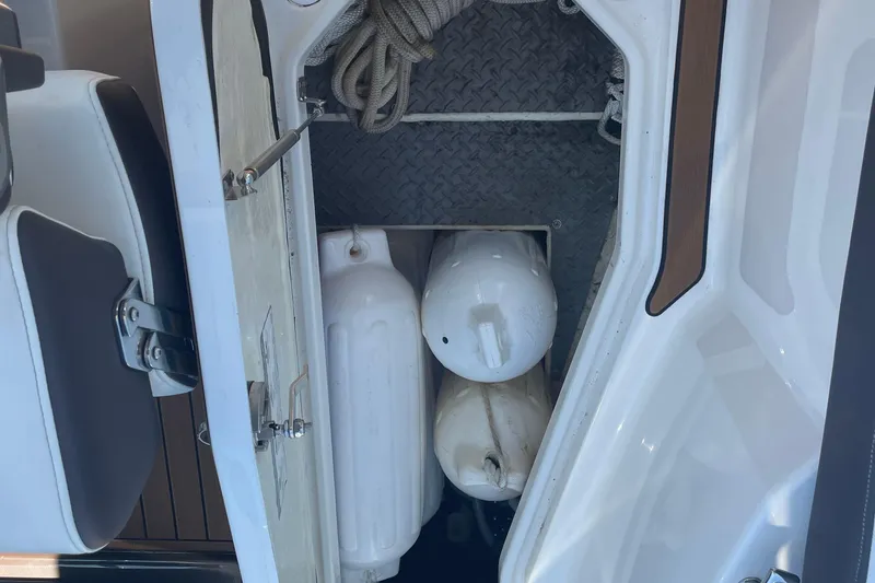 Slide: The Image of Storage compartment on a 2018 Monterey 328 Super Sport boat with fenders and rope. - 15