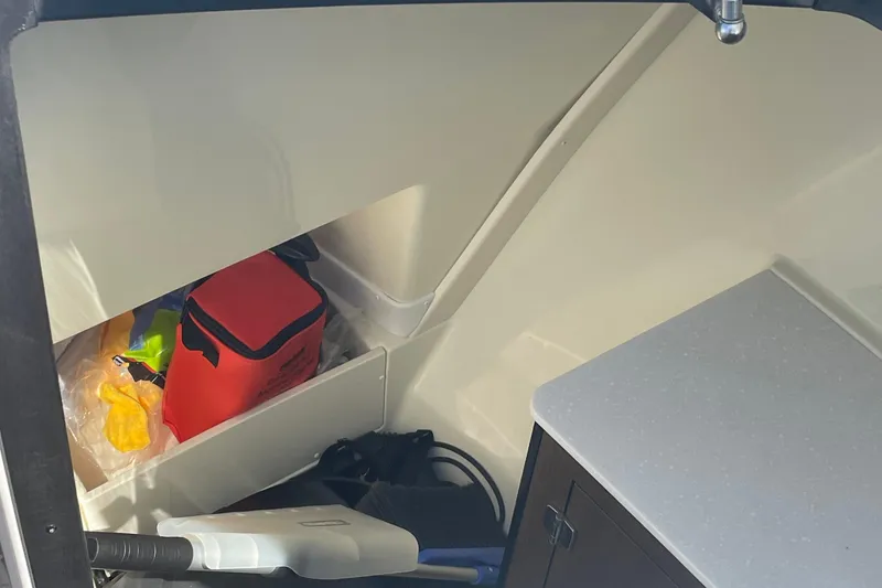 Slide: The Image of Interior storage area of a 2018 Monterey 328 Super Sport boat with various items. - 20