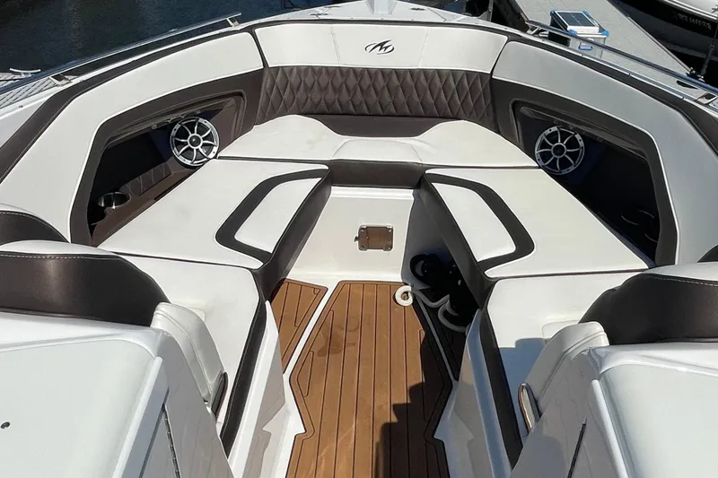 Slide: The Image of 2018 Monterey 328 Super Sport boat interior with luxurious seating and wood flooring. - 24