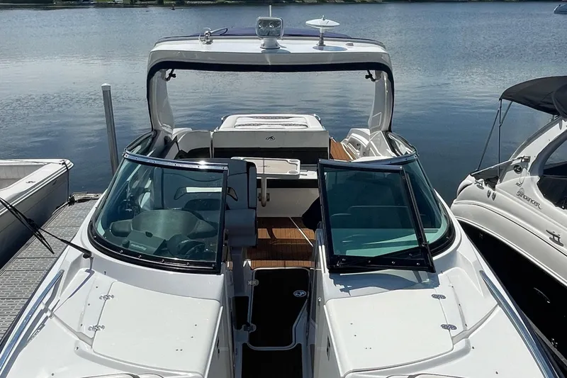 Slide: The Image of 2018 Monterey 328 Super Sport boat docked on calm water. - 26