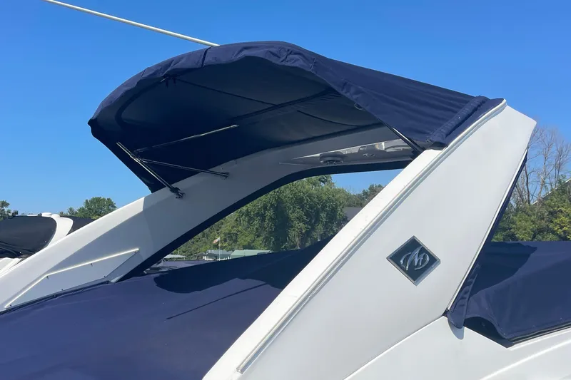 Slide: The Image of 2018 Monterey 328 Super Sport boat with blue canopy and sleek design. - 5