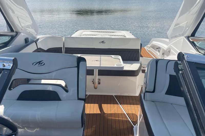 Slide: The Image of 2018 Monterey 328 Super Sport boat interior with luxurious seating and wooden flooring. - 6