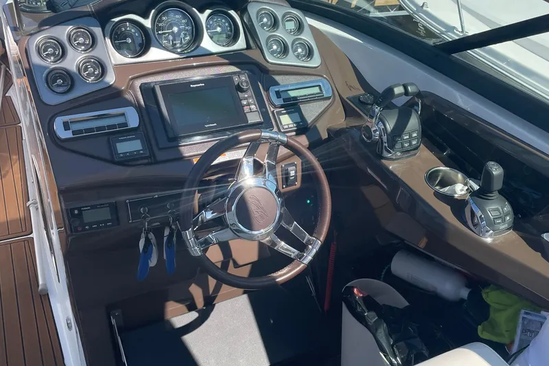 Slide: The Image of Cockpit of 2018 Monterey 328 Super Sport boat with modern controls and steering wheel. - 8