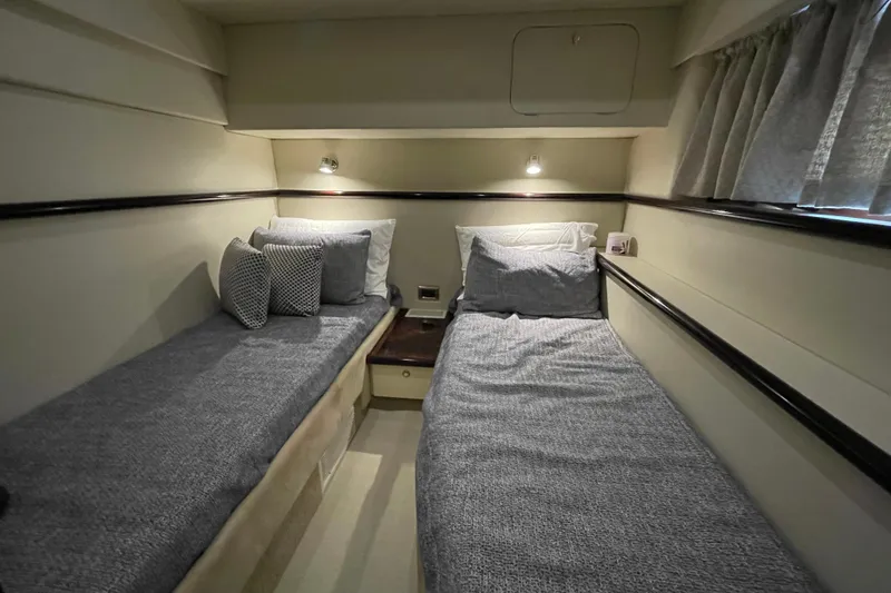 Slide: The Image of 1997 Sunseeker Camargue 51 cabin with twin beds, cozy lighting, and elegant decor. - 20