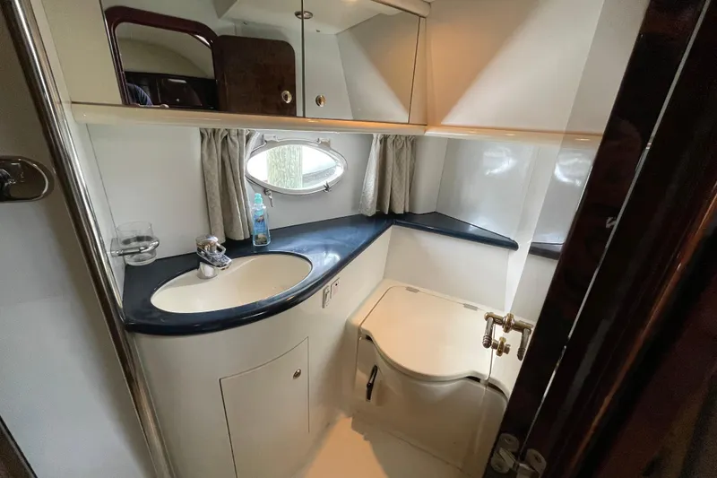 Slide: The Image of Bathroom interior of 1997 Sunseeker Camargue 51 yacht, featuring sink and porthole window. - 22