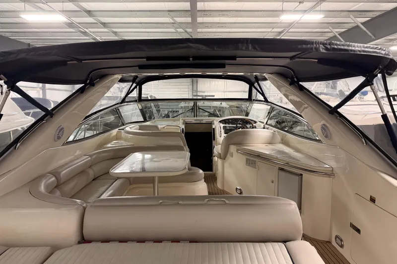 Slide: The Image of 1997 Sunseeker Camargue 51 yacht interior with seating and helm, under a covered dock. - 3