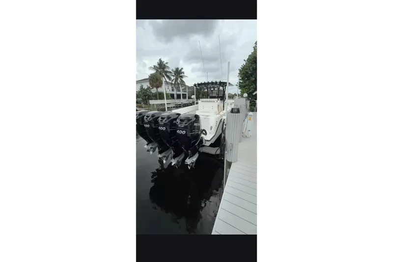 Slide: The Image of 2020 Contender 39 ST boat docked with four powerful outboard engines. - 14
