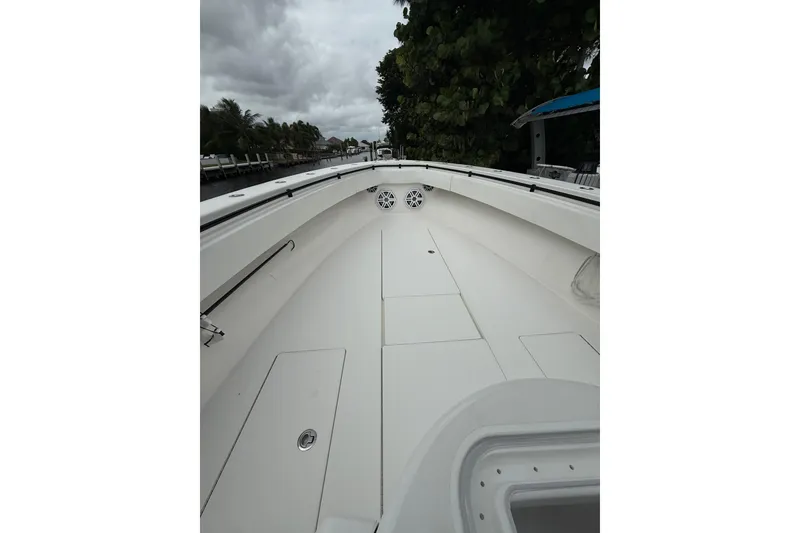 Slide: The Image of 2020 Contender 39 ST boat interior with sleek white deck and storage compartments. - 15