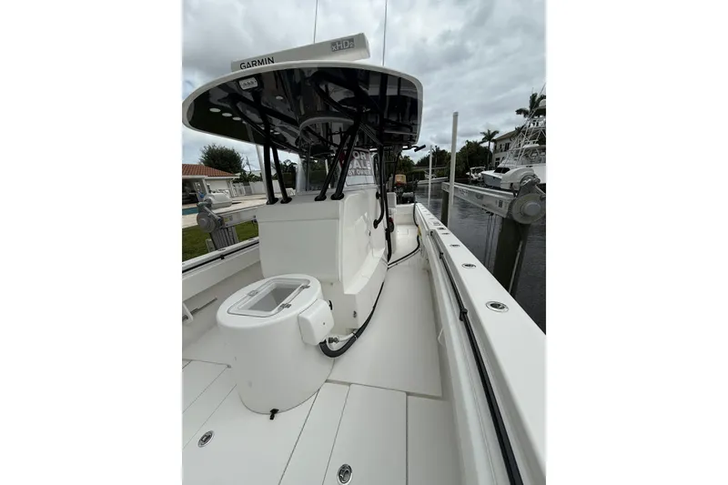 Slide: The Image of 2020 Contender 39 ST boat with Garmin equipment, docked near waterfront homes. - 18