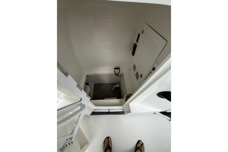 Slide: The Image of Interior view of 2020 Contender 39 ST boat cabin, showing compact space and equipment. - 19