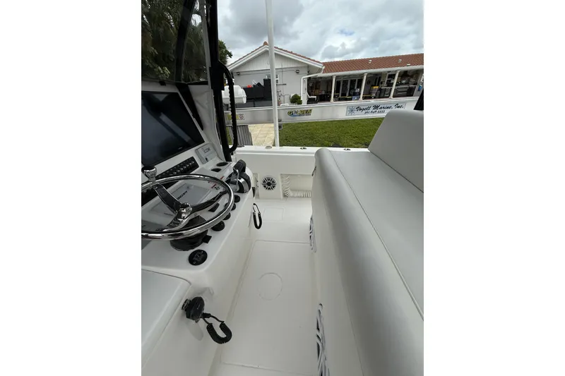 Slide: The Image of 2020 Contender 39 ST boat interior with steering wheel and seating area. - 23