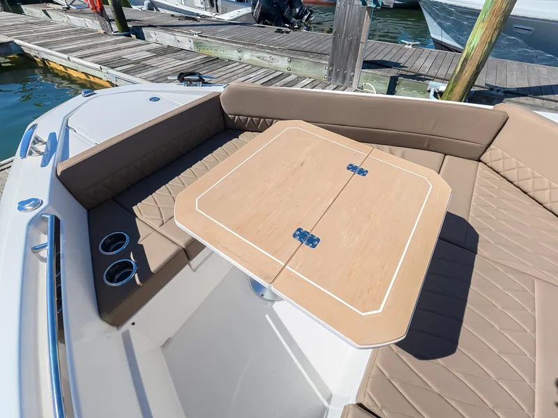 Slide: The Image of A 2027 Saxdor 400 GTO with a sleek folding wooden table and cushioned seating at the dock. - 20