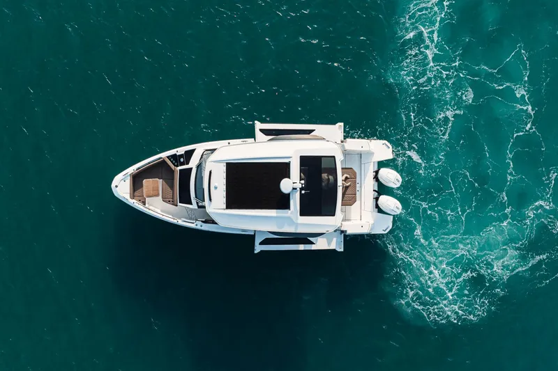 Slide: The Image of Aerial view of a 2027 Saxdor 400 GTO on blue water with two outboard engines. - 32