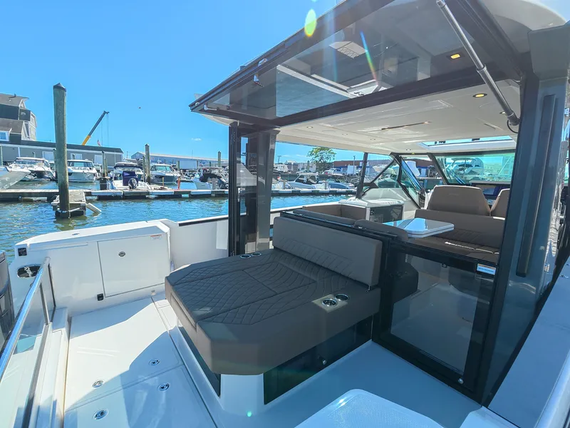 Slide: The Image of The image shows the deck of a 2027 Saxdor 400 GTO at a marina. There are seating areas and a table. - 4