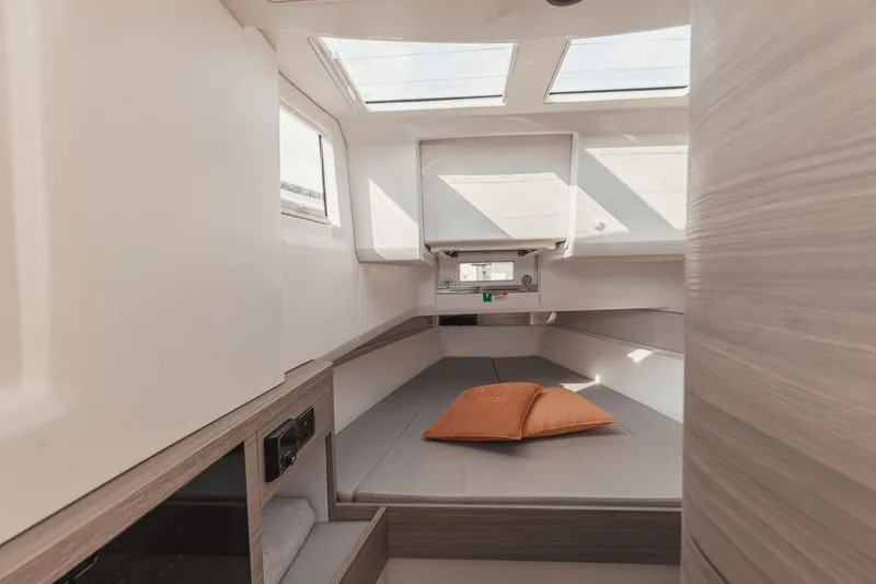 Slide: The Image of Interior of a modern cabin with skylights and a bed featuring orange pillows. - 25