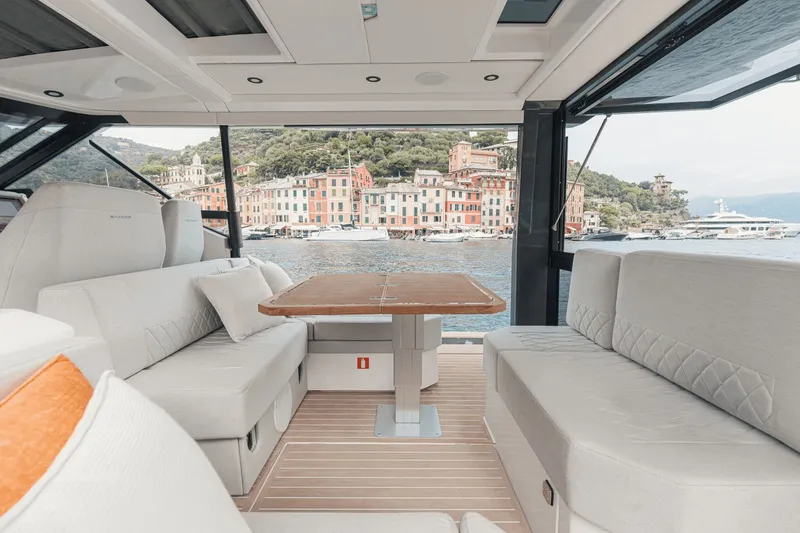 Slide: The Image of The interior of a 2027 Saxdor 400 GTO features an elegant seating area with a wooden table. - 8
