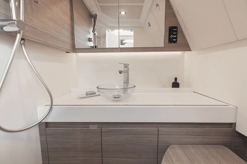 Slide: The Image of Modern bathroom on a Saxdor 400 GTO boat with glass sink and wooden cabinets. - 1