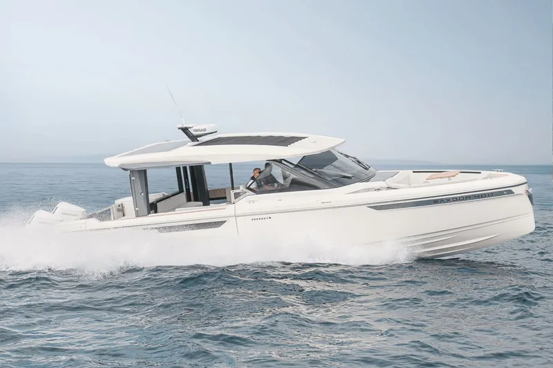Slide: The Image of A modern Saxdor 400 GTO boat from 2027 speeds across the sea, featuring sleek design and spacious deck. - 42