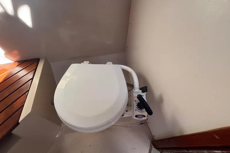 Slide: The Image of Marine toilet in 1988 Catalina 34 sailboat, featuring a manual pump handle. - 20