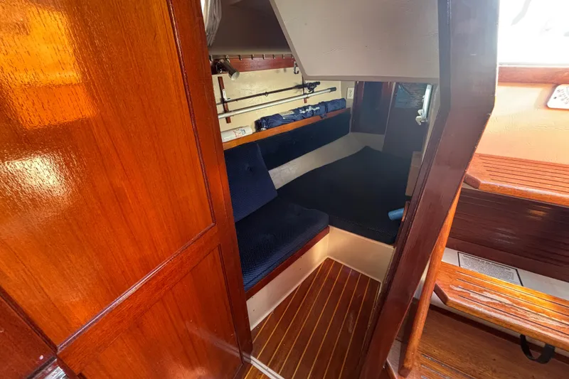 Slide: The Image of Interior of 1988 Catalina 34 sailboat with wooden finish and cozy seating area. - 22