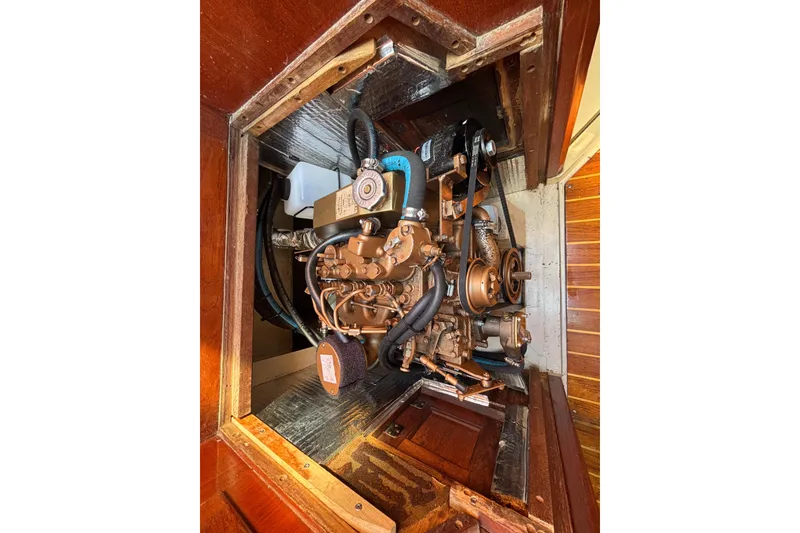 Slide: The Image of Engine compartment of a 1988 Catalina 34 sailboat, showcasing detailed mechanical components. - 26