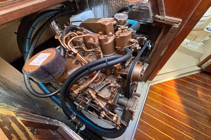 Slide: The Image of Engine compartment of a 1988 Catalina 34 sailboat, showcasing detailed mechanical components. - 28