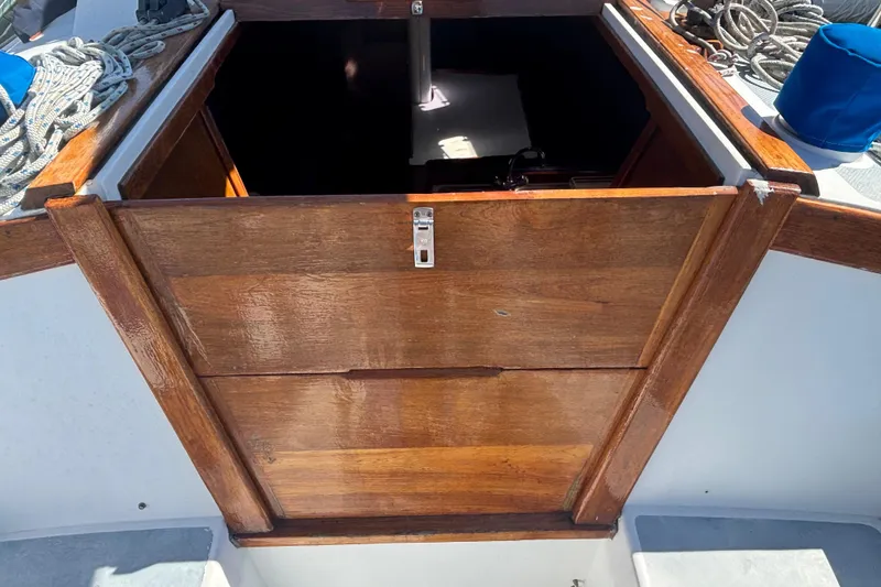 Slide: The Image of Wooden hatch entrance on a 1988 Catalina 34 sailboat deck, surrounded by ropes. - 3