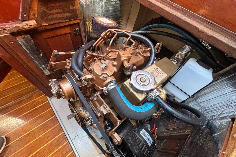 Slide: The Image of Engine compartment of a 1988 Catalina 34 sailboat, showcasing detailed mechanical components. - 30