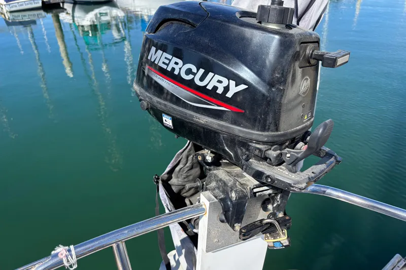 Slide: The Image of Mercury outboard motor on 1988 Catalina 34 sailboat, docked in marina. - 34