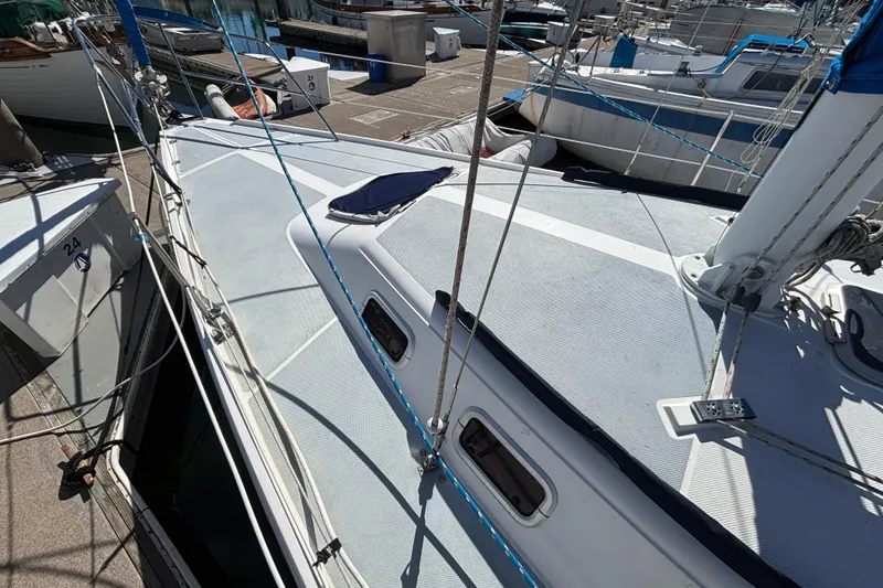 Slide: The Image of 1988 Catalina 34 sailboat docked, showcasing deck and rigging details. - 41