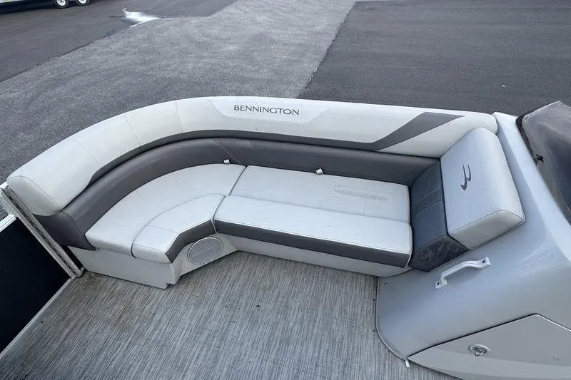 Slide: The Image of 2023 Bennington 22 SX Swingback boat interior with gray and white seating. - 14