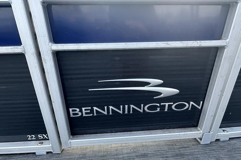 Slide: The Image of 2023 Bennington 22 SX Swingback pontoon boat logo on side panel. - 16