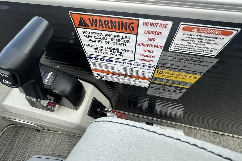 Slide: The Image of Warning labels and controls on 2023 Bennington 22 SX Swingback boat dashboard. - 18