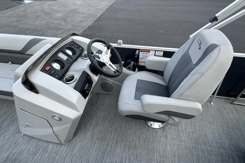 Slide: The Image of 2023 Bennington 22 SX Swingback boat interior with steering console and captain's chair. - 22