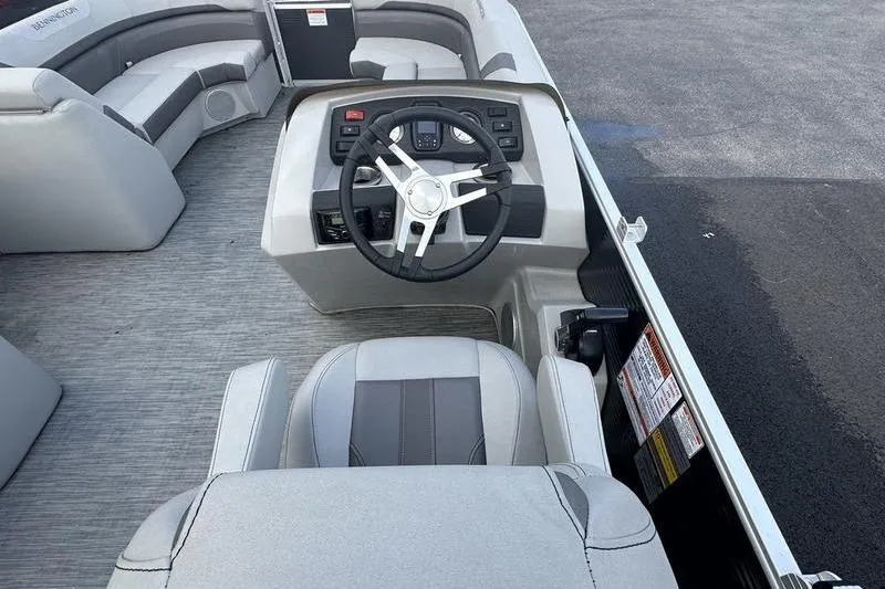 Slide: The Image of 2023 Bennington 22 SX Swingback boat interior with steering wheel and seating. - 23