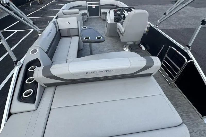 Slide: The Image of 2023 Bennington 22 SX Swingback pontoon boat interior with gray seating and cup holders. - 24