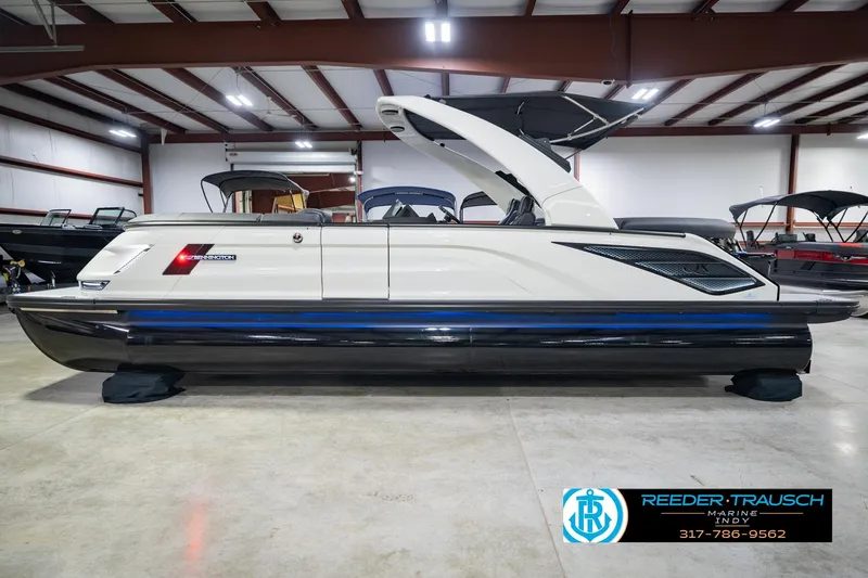 Slide: The Image of 2026 Bennington QX 25 QXFBA pontoon boat in showroom, side view. - 11