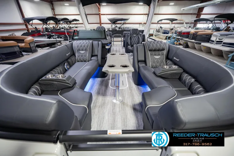 Slide: The Image of Luxurious 2026 Bennington QX 25 QXFBA pontoon boat interior with plush seating and modern design. - 16