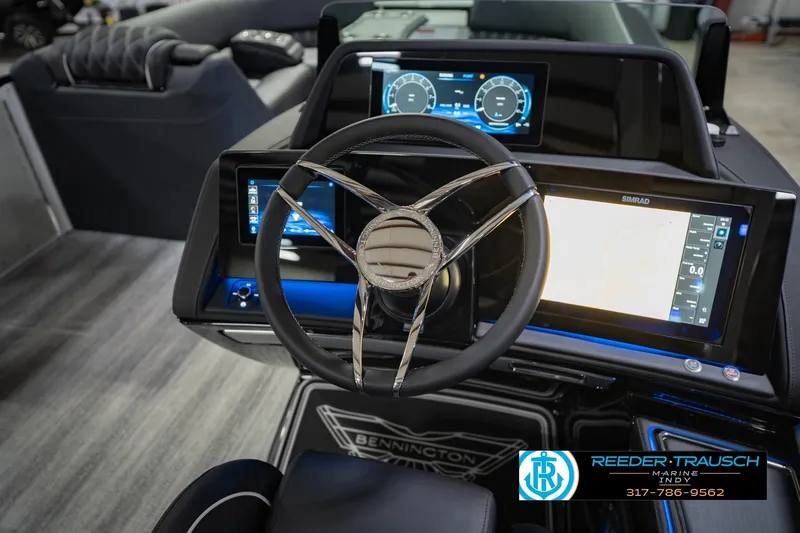 Slide: The Image of 2026 Bennington QX 25 QXFBA boat dashboard with advanced digital displays and steering wheel. - 28