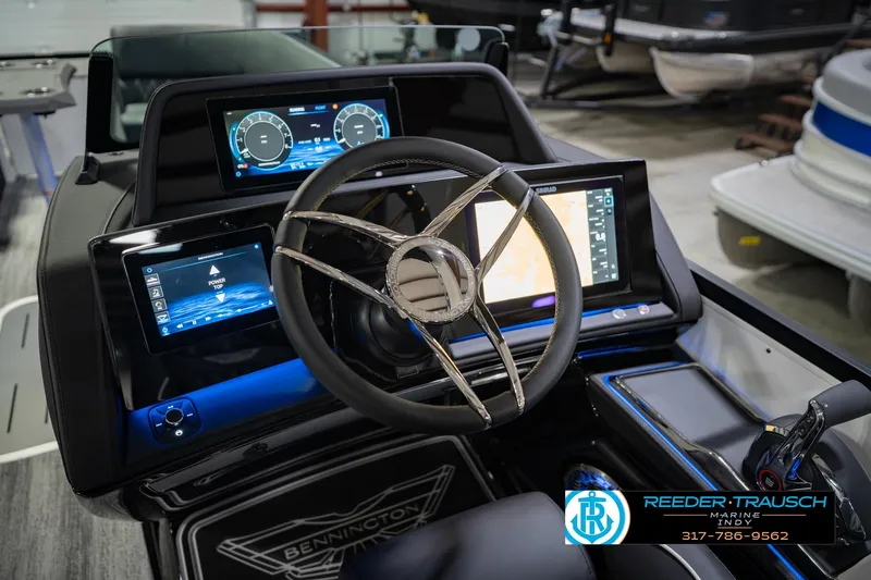 Slide: The Image of 2026 Bennington QX 25 QXFBA boat dashboard with advanced digital displays and steering wheel. - 29