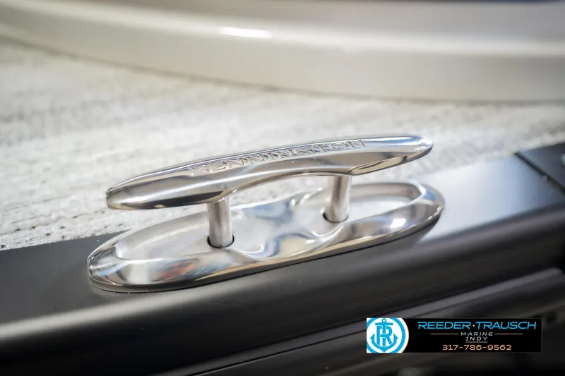 Slide: The Image of Close-up of a 2026 Bennington QX 25 QXFBA boat cleat, featuring Reeder Trausch Marine logo. - 57