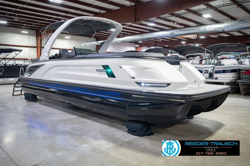 Slide: The Image of 2026 Bennington QX 25 QXFBA pontoon boat in showroom, sleek design, modern features. - 6