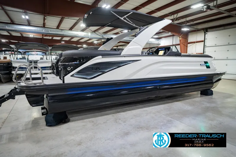 Slide: The Image of 2026 Bennington QX 25 QXFBA pontoon boat displayed indoors at Reeder Trausch Marine. - 8