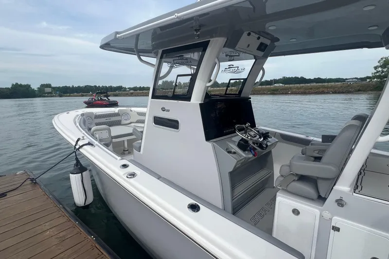Slide: The Image of 2024 Sea Pro 322 Offshore boat docked, featuring sleek design and modern controls. - 11